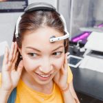 5 ways wearable tech is revolutionizing healthcare 38 Woman with digital headwear equipment sensor connected to her ear, reading brain impulses. Future technology concept